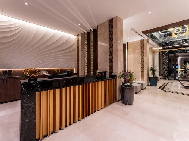 Hospitality reception with carved wall relief and timber detailing