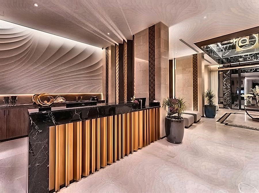 Reception desk in dark marble and brushed brass