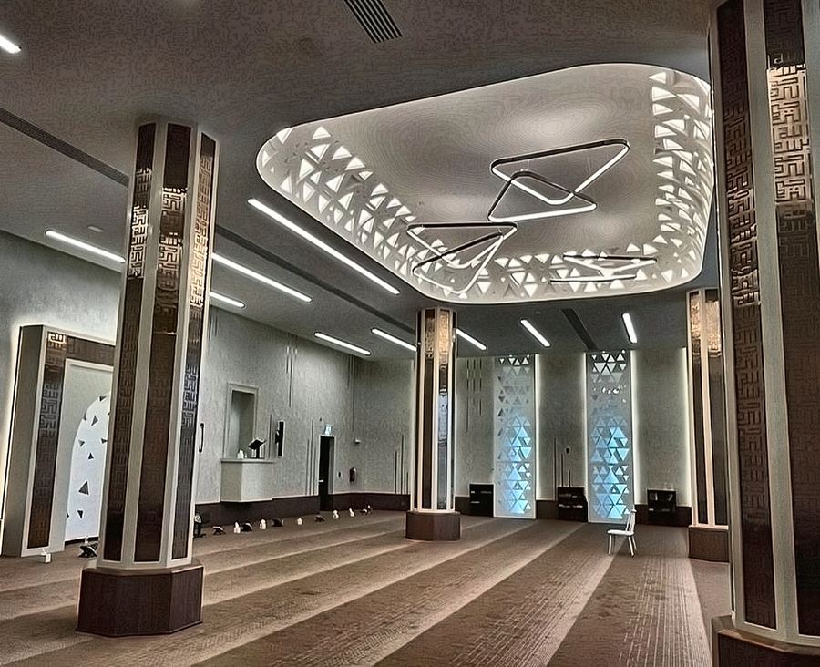 Prayer hall with a perforated illuminated ceiling